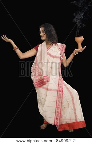 Young Bengali woman performing ritual dance