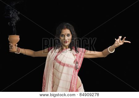 Bengali woman performing ritual dance