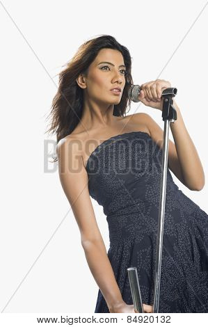 Woman singing into a microphone