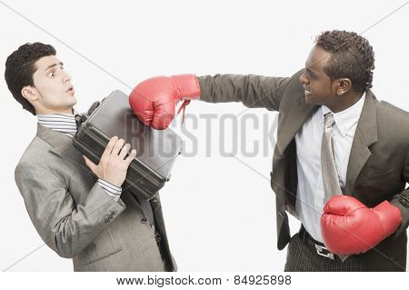 Businessman defending himself from the punch of his colleague
