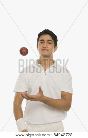 Bowler tossing a cricket ball