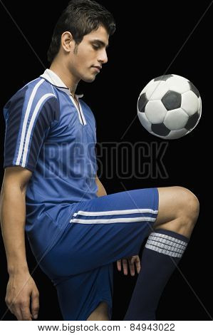 Soccer player practicing with a soccer ball