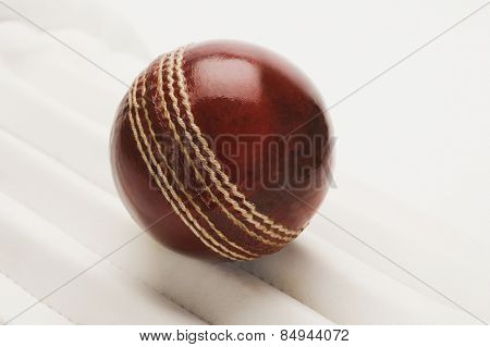Close-up of a cricket ball on a cricket pad