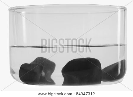 Close-up of stones sunk in a bowl of water
