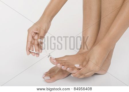 Woman clipping her toenails