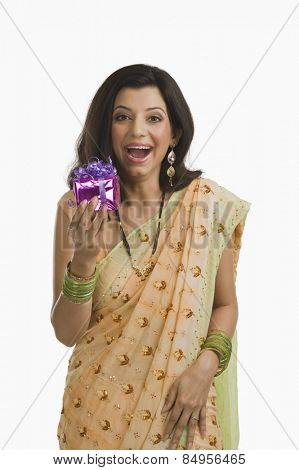 Surprised woman holding a Diwali gift
