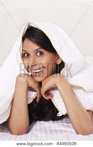 Woman covering herself with a bedsheet