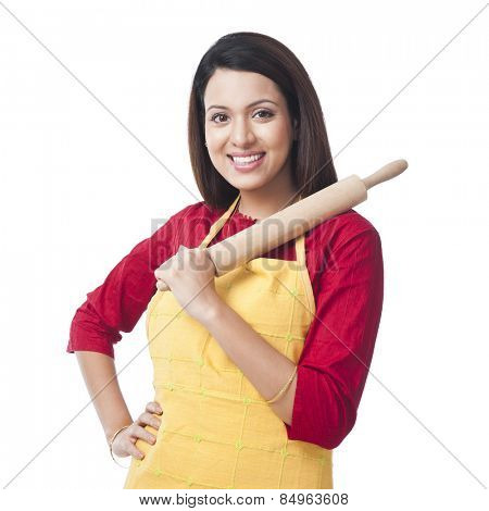 Portrait of a woman holding a rolling pin and smiling