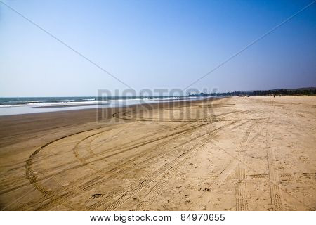 Tire tracks and footprints on the beach, Morjim, Pernem, Goa, India