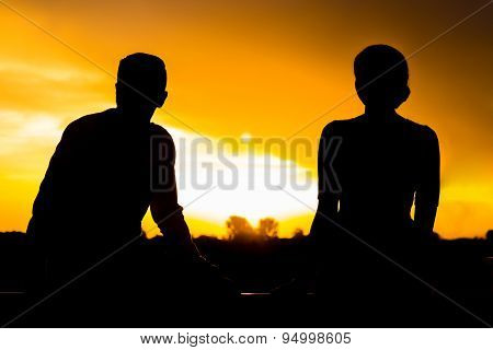 Two Silhouettes At Sunset