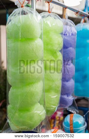 Bags of colorful cotton candy for sale at market. spun sugar