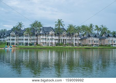 Lovely view of the lake near luxurious tropical resort over cloudy sky during day