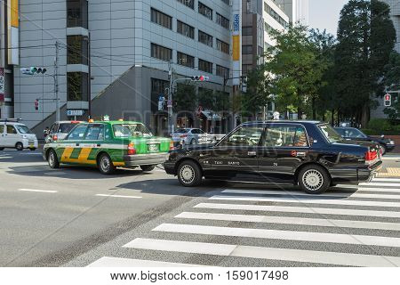 Tokyo, Japan - 18 NOV 2016 : Taxi car waiting for turn right at junction near Tsukiji market on 18 November 2016