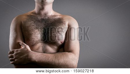 Man with hairy chest isolated on black background.