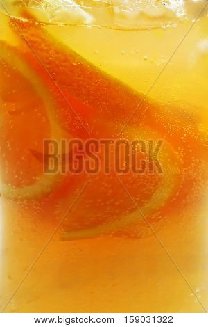 orange fruit punch cocktail drink with lemon and ice