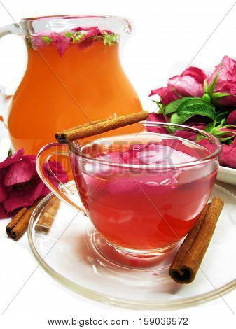 rose tea punch cocktail in jug and cup with cinnamon