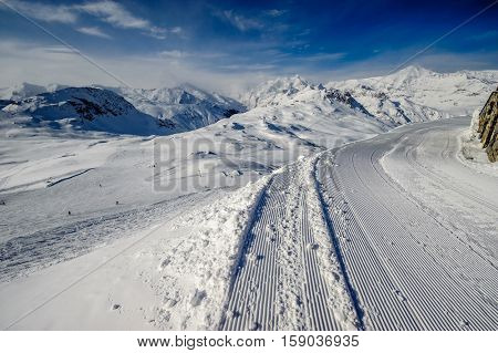 Alpine winter mountain landscape. French Alps covered with snow in sunny day. Val-d'Isere, France