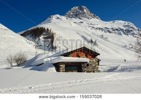 Alpine winter mountain landscape. French Alps covered with snow in sunny day. Val-d'Isere, France