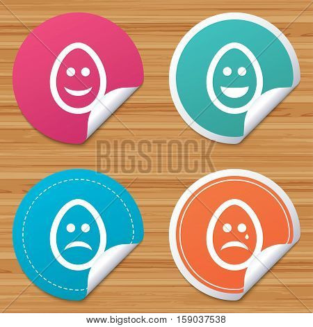 Round stickers or website banners. Eggs happy and sad faces icons. Crying smiley with tear symbols. Tradition Easter Pasch signs. Circle badges with bended corner. Vector