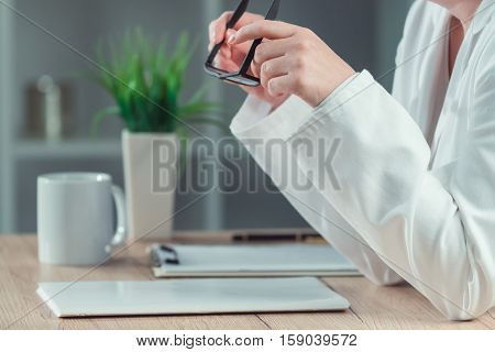 Female doctor reading patient medical history record in hospital office healthcare and medicine professional at work