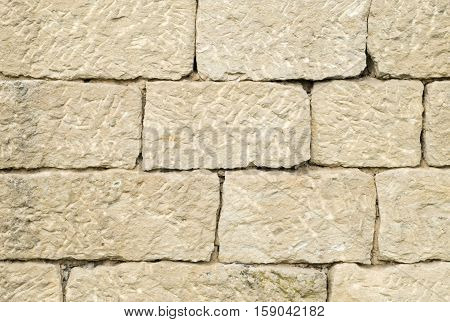 Old stone wall closeup in sunny day