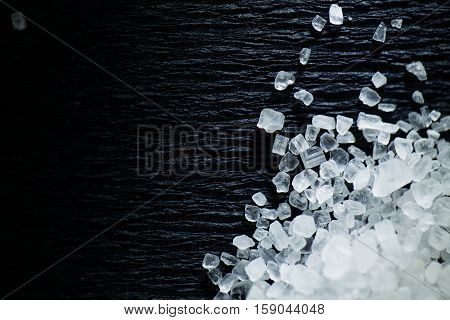 Coarse sea salt on a dark background