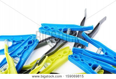 Pile of plastic cloth pegs isolated over white background