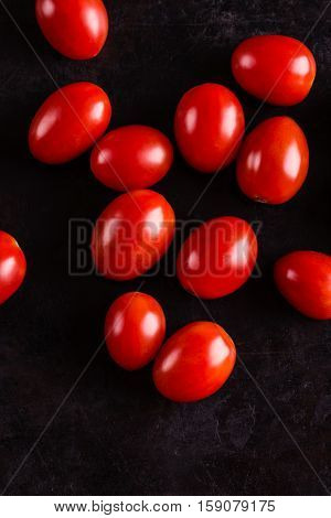 Top View On Several Red Cherry Tomatoes On Black Board