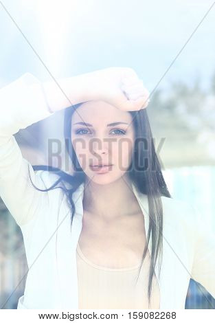 business woman looking thtough window in the office