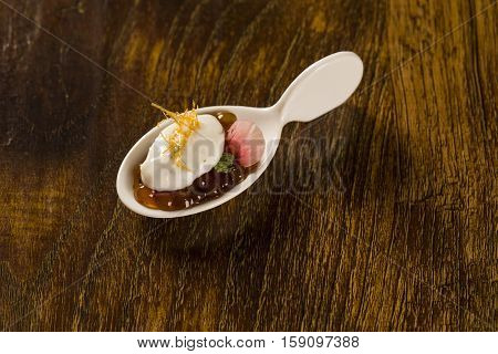 Natural Flavored Mint Yogurt, Pepper Sago Finished With Caramel In A Spoon. Taste Gastronomy Finger
