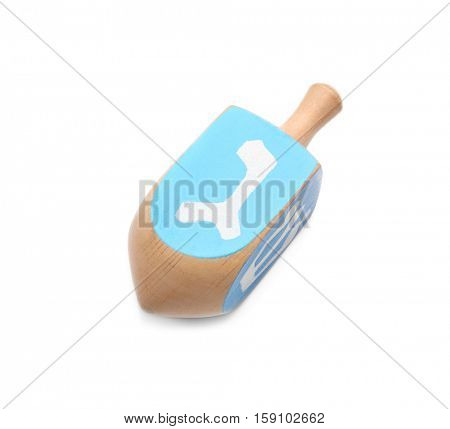 Wooden dreidel for Hanukkah on white background
