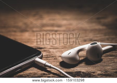 Headphone And Phone Media Portable On Dark Tone.