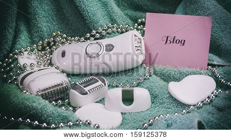 Epilatory With A Turquoise Background, Words On Pink Paper