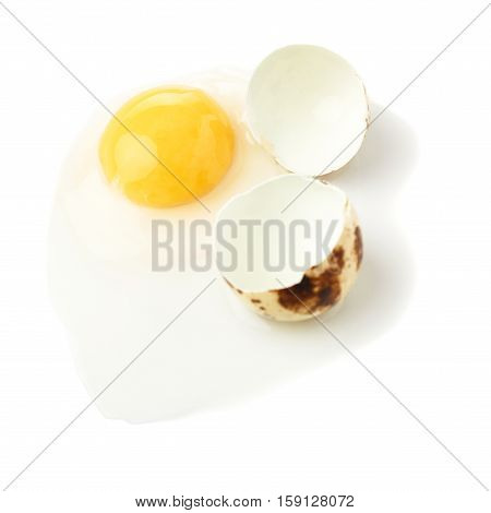 Single cracked raw quail egg with yolk isolated over white background
