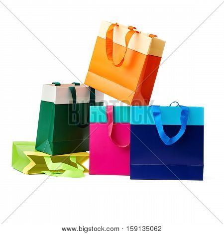 Stack of colorful shopping or gift bags isolated over the white background