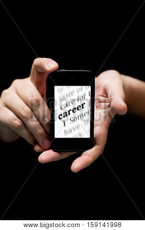 Hands Holding Smartphone showing the Word Career printed concept of finding jod online (on black background with very shallow depth of field)