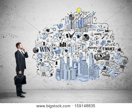 Side view of thoughtful caucasian businessman looking at creative business sketch drawin on concrete wall