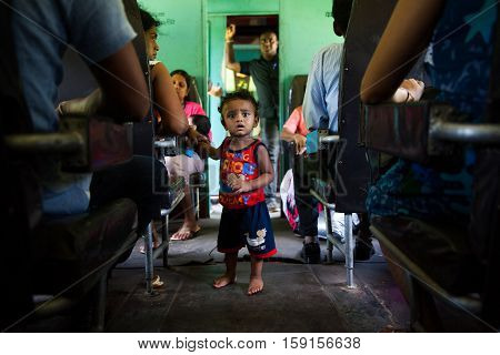 HIKKADUWA SRI LANKA - NOVEMBER 17 : COMMUTERS SITTING IN TRAIN TO COLOMBO NOVEMBER 17 2015 IN HIKKADUWA SRI LANKA