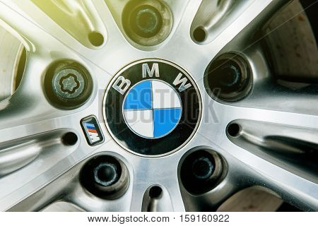MUNCHEN GERMANY - APRIL 06 2015: BMW electric limousine alloy wheel detail with logotype of BMW on it and sun flare