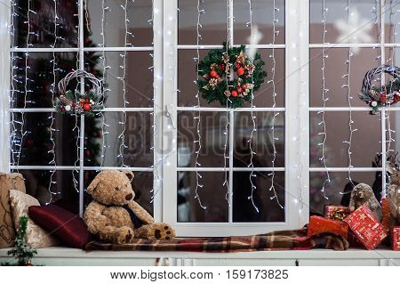 Holiday Decoration On The Windowsill Covered With Woolen Plaid.