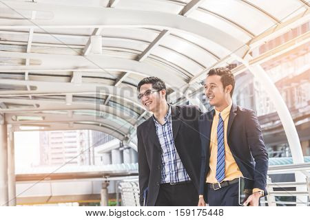 Two Businessman Dicussing Business In Central Of City. Concept Of Modern Business