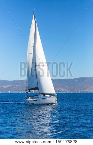 Sailing ship boats with white sails in the Sea. Luxury yachts.