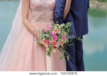 Beautiful Bridal Bouquet In Hands Of The Bride. Wedding Bouquet Of Peach Roses By David Austin,  Sin