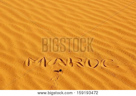 French Word Maroc Written On The Sand