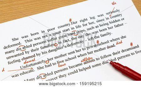 english proofreading sheet with red marks on table