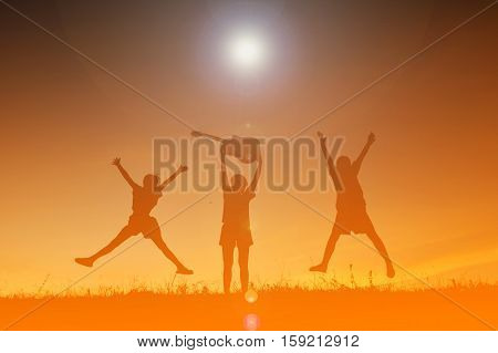 Silhouette of people playing guitar at the sky sunset happy time in holiday vintage tone