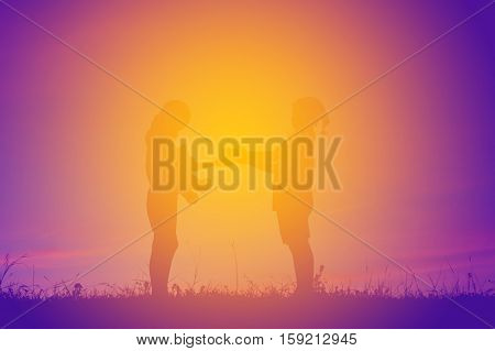 Silhouette of children holding gift box at the sky sunset happy time in holiday Christmas and happy new year concept
