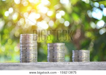 coin on wood tree bokeh background. selective focusconcept save money for my home