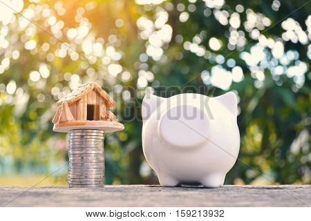 piggy bank with a coin on old wood bokeh background.concept save money