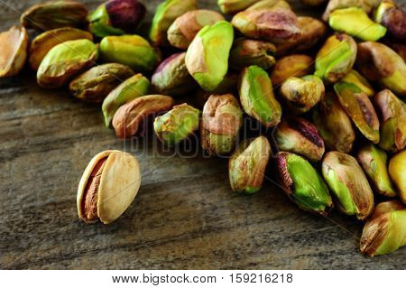 Close-up image of pistachios on wooden background
